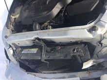 There’s a bracket on the passenger side. 
And oh yeah you need to remove the hood latch assembly 