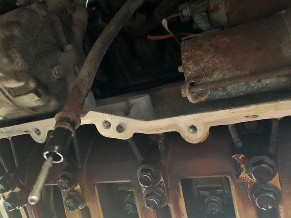The dipstick tube and front side of the engine