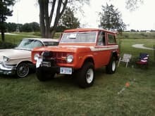 My dad and I's 1976 Bronco at a car show next to my grandpa's '59 Cadillac. The Bronco no longer has a winch or the large bumper, instead it has a stock chrome one now.
