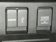 Center Console Ports.  HDMI, USB, and 12V Cigarette power port.  Each has a cover.  The USB port actually has a USB drive in it, and the cover still closes!