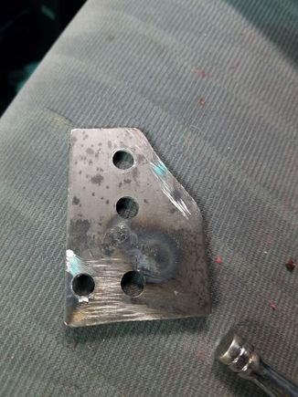 Final plate.  The angled cut is necessary to clear the shifter boot cover. Bottom two holes for mounting.  I drilled two holes to try different throw angles.  Utilizing the top hole brings the throw down to 2.75 inches.