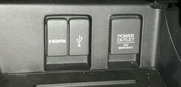 Center Console Ports.  HDMI, USB, and 12V Cigarette power port.  Each has a cover.  The USB port actually has a USB drive in it, and the cover still closes!