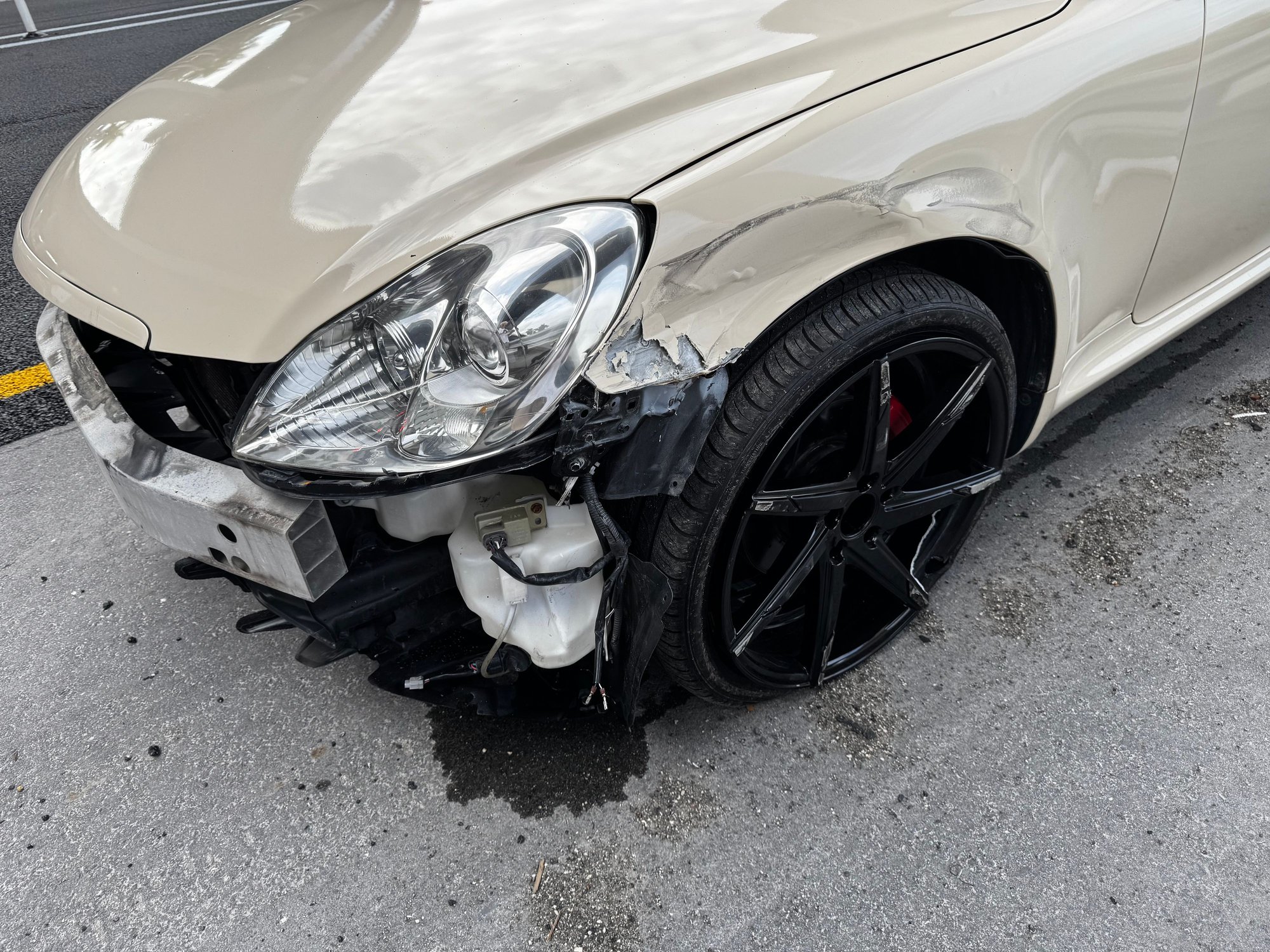 Trashed front wheel and tire at accident site.  This was the only reason car could not be driven off highway, requiring tow to body shop.