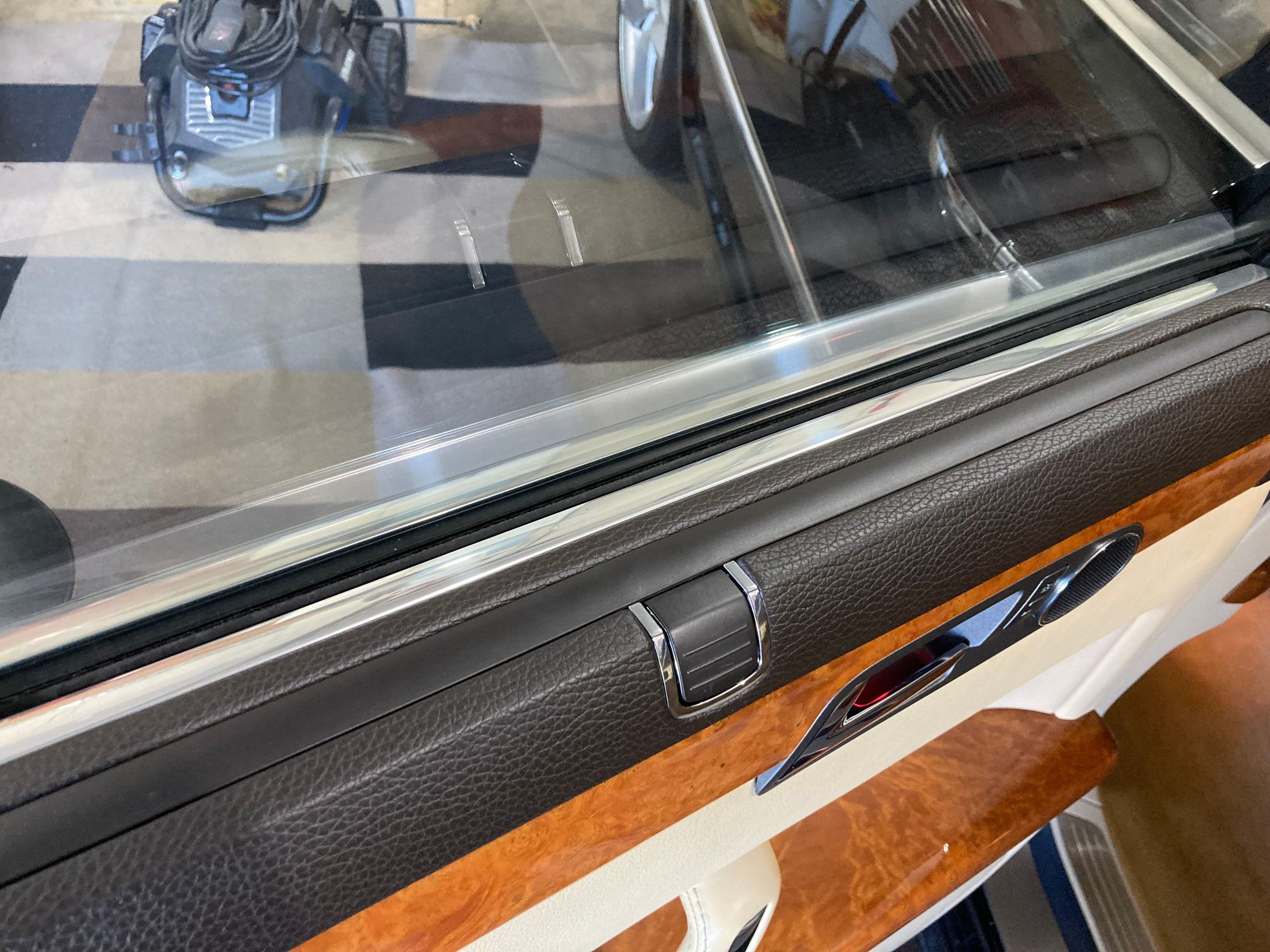 Just look at the sun shade area, there is a chrome metal strip bordering the glass on both sides and the shade is click retained/hidden when down. 