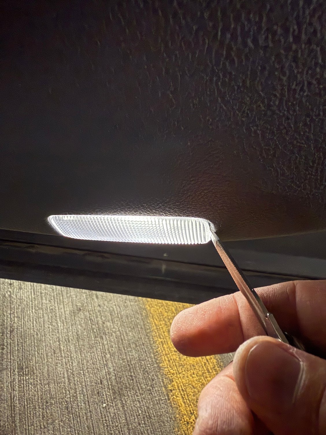 Old light pries out with thin flathead screwdriver
