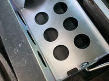 Steel mounting tray bolted to the frame