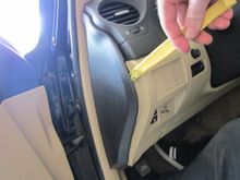 with a trim tool pry the side cover off. also on passenger side