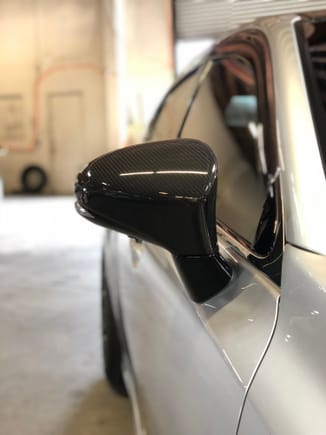Had the mirror post vinyl wrapped black to better flow with the carbon mirrors 
