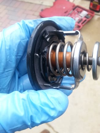 About a 3/4" piece of internal  rubber seal (not the housing to thermostat seal) had split and wedged between thermostat valve preventing engine warm up.
