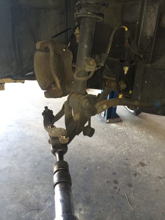 The two caliper bolts were removed and the caliper was hung out of the way using zip ties.
The upper control arm was removed from the spindle along with the lower and the spindle was set aside.