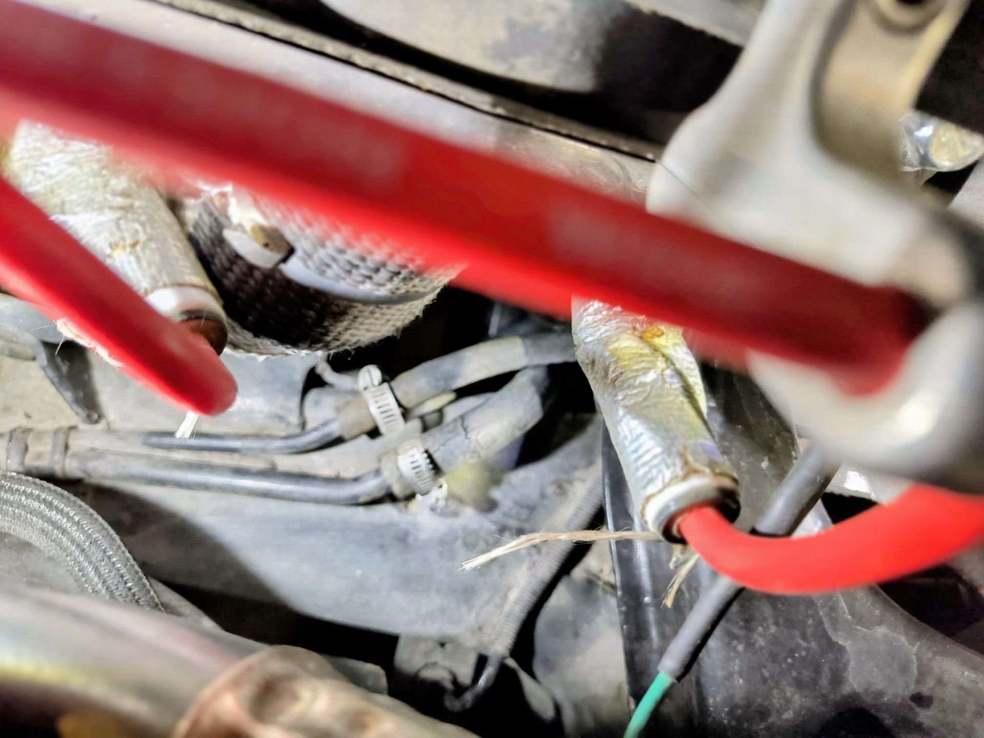 Unprotected fuel lines inches from the headers 