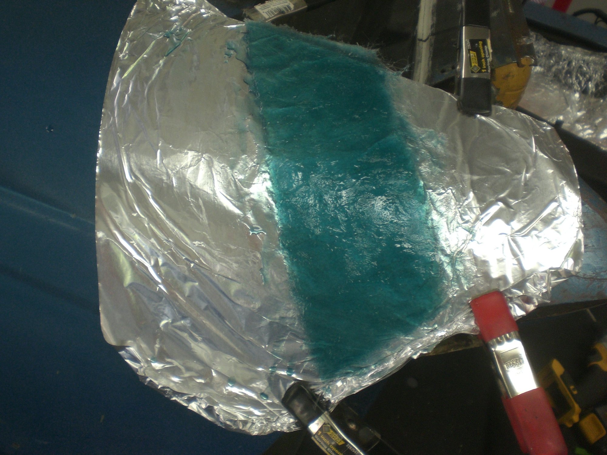 Fiberglass bonding strip made for remounting the cut fender tip after windshield frame corners were replaced.