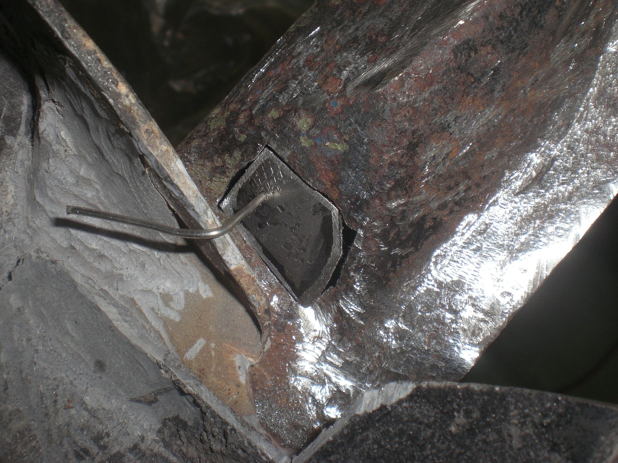 Pillar rust hole was enlarged a bit and a small patch piece was welded in.