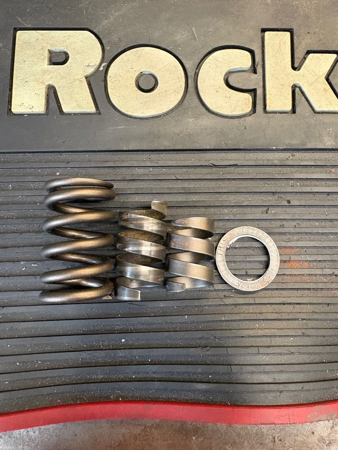 Valve spring, new damper, old damper, & spacer.