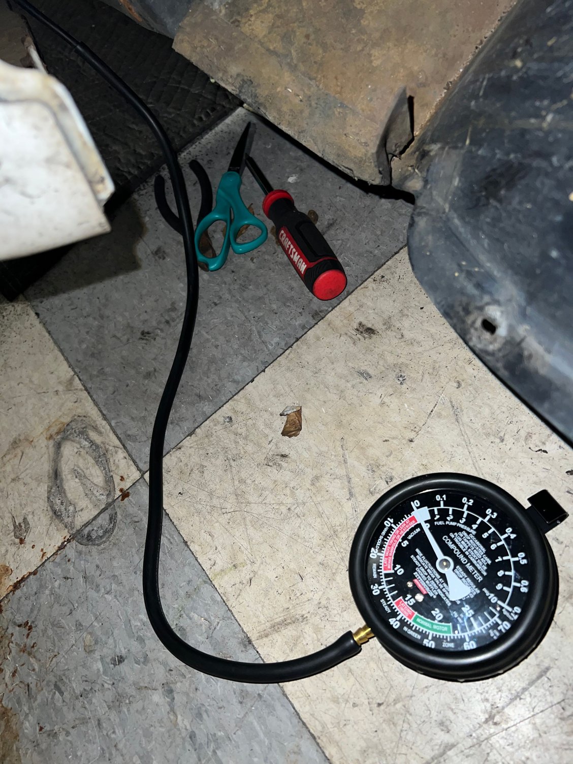 Vacuum gauge attached to vacuum supply hose coming from intake manifold 