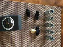 The steel Summit ptfe hose ends, two couplers and an adapter for a 1/4” quick disconnect I can attach to my air compressor, and a fuel pressure gauge and coupler. 