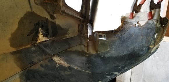 portion of wheel well cut away to give access to inside body repair