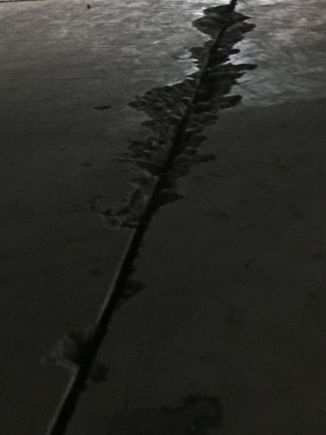 This is a saw cut inside the shop that is chipping away from heavy metal wheels rolling over them