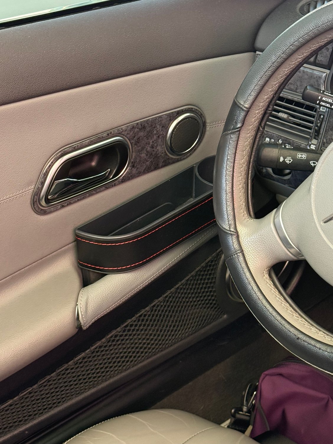 Cup holder, driver side, includes slot for phones, etc.