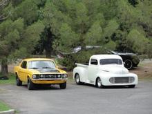 At a Veterans day car show at a retirement home here in Cruces where the majority of the Veterans are... That white Ford next to me belongs to my car club's former president (current chaplain)... it's chopped, channeled, lowered, and has an OLD's 455 in it... yea it smokes em'!