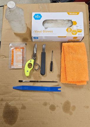 These are the items I used to replace the wheel center badges. I used the back of the brush to pry the center cap up enough to use the trim removal tool to pop it off. I didn't want to use a screwdriver and add anymore damage.