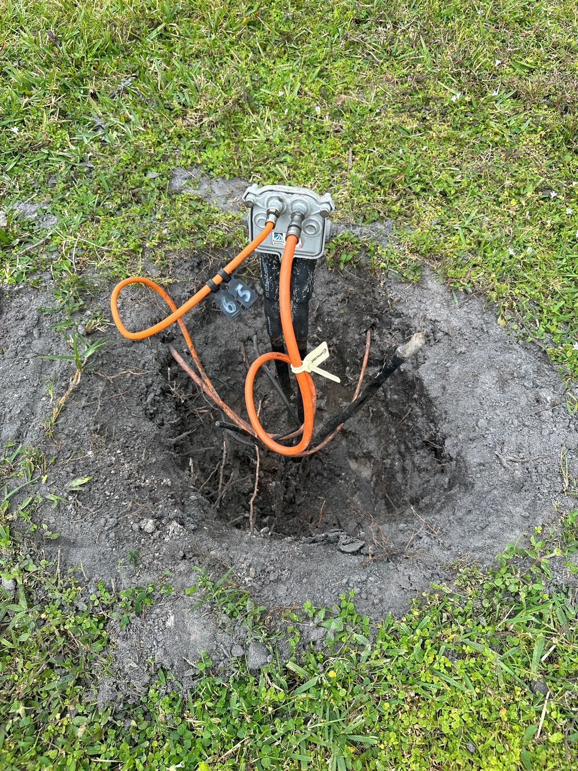 How can I bury Comcast's electrical cables?