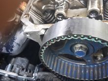 Here you can see what the alternator tensioner adjuster officially turned out to look like hehe. But anyway this pic shows how I'm trying/hoping/praying the timing doesn't get messed up. I used some paint to mark on the pulley and belt. I did this on the front side here and on the back also. So if the belt doesn't move, and the pulleys don't move, the timing should stay the same right?