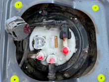 Top of the fuel hanger, beneath rear seats