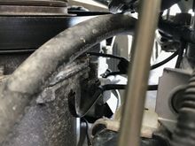 This is a cut wire where I assume that plug connected which is attached to a bracket on the side of the condenser.