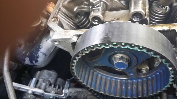 Here you can see what the alternator tensioner adjuster officially turned out to look like hehe. But anyway this pic shows how I'm trying/hoping/praying the timing doesn't get messed up. I used some paint to mark on the pulley and belt. I did this on the front side here and on the back also. So if the belt doesn't move, and the pulleys don't move, the timing should stay the same right?