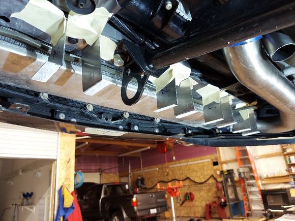 here you can see i installed the little brackets on the core support.  I put white latex paint on the feet so it would mark the right spot for where they needed to be welded