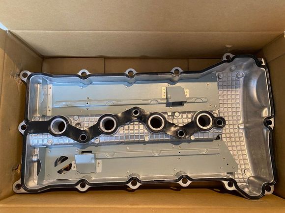 The OEM aluminum valve cover (1035A810) comes with an included gasket.