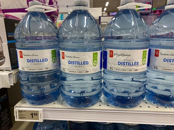 Distilled water can be bought at drug stores for cheap.