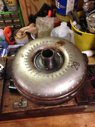 Torque converter. This one appears to have been replaced once before. It has, ".   TAP
(.     O       )
BBLANCER" 
across the back side in yellow paint marker. If that's the case, someone may have already changed out some of the parts in this.
