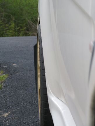 passenger side, point from front of car to rear to show the *poke* of rear tire.. just about flush.