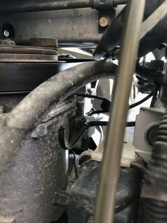 This is a cut wire where I assume that plug connected which is attached to a bracket on the side of the condenser.