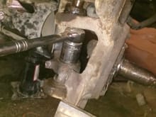 A picture of my stupidity, thought I had enough room to take the nut off with the ratchet and got it wedged between top of lower ball joint and the bottom of the upper spindle/ball joint. Had to go out and buy a cutting wheel for my drill and cut the lower ball joint to get it free. That took a while, I think I stared at it for 45 minutes trying to figure out how I did it.