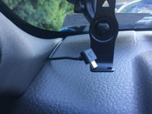 Route the cord along the edge of the dash and tuck it into the space between the front of the dash and the windshield.  This keeps the cord out in the open to allow the traffic receiver antenna built into the cord to not be shielded by the metal in the body.