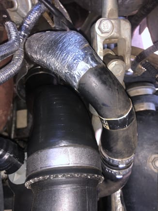 Here is the driver side turbo discharge hose with an oily sheen that returns after cleaning. 