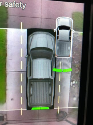 As you get closer to an object, the green bars move closer to the picture of the truck.