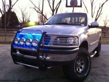 Stainless steel brush guard, X4 Stainless steel 100W KC lights, Black projectors with 10000K HIDs in high and lows, Have 10000K HIDs for the KCs just havent installed them yet. Billet Grill, custom blue LEDs
