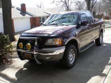 My '02 King Ranch that is in better shape than I'm in!  A few things have changed since I did my signature, notably, 130W KC Daylighters on the push bar, and the SS headache rack.
