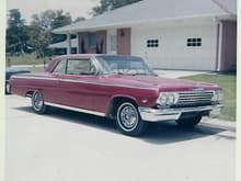 1962 Impala I had when a Senior in high school. 327 with 3 speed on floor. Dual glasspack's, exhaust cutout's, 4 barrel carb and had Corvette finned valvecover's. Picture taken in summer of 1965, I later put chrome reversed wheel's on this car and tinted the glass.