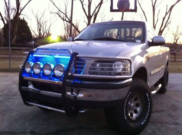 Stainless steel brush guard, X4 Stainless steel 100W KC lights, Black projectors with 10000K HIDs in high and lows, Have 10000K HIDs for the KCs just havent installed them yet. Billet Grill, custom blue LEDs