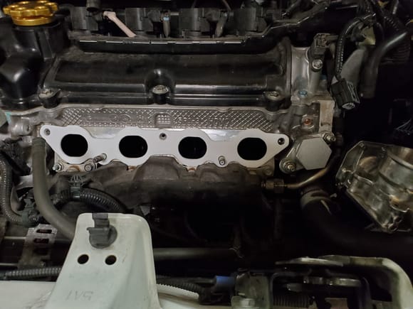 Their EGR block off was prettier than mine but the holes had to be widened to fit over the studs. I drilled them out. 