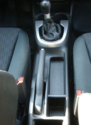 What do you do with the container/tray beside the hand brake? Has anyone made a cover?