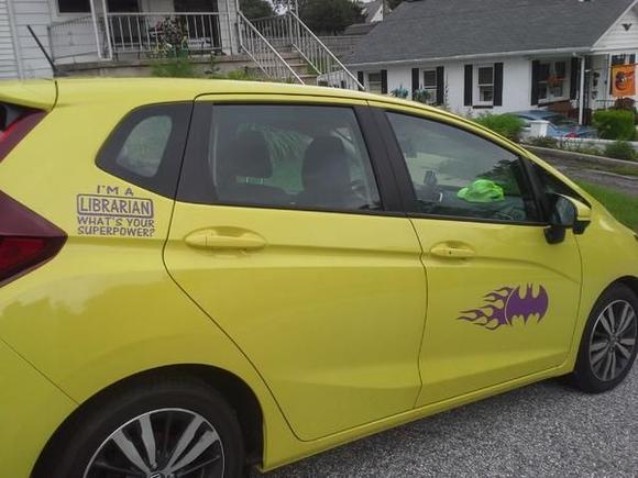 passenger side, Batman logo with Flames on door.  Upper sticker reads "I'm a Librarian, what's your superpower?"  (Batgirl's secret identity of course, is Barbara Gordon, librarian.)