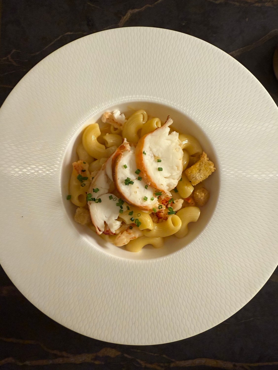 Lobster mc and no cheese - no gratin and no cheese but ok otherwise. Interestingly much neater pieces of lobster tail than in other poster’s photo. Cost saving means that apart from the garnish, they use tiny pink shrimps rather than lobster in the actual dish. Not bad despite the shortcomings. 