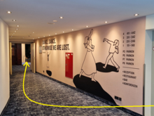 In the parking garage, go up to the hotel and make a right turn after the doors open. At the tip of the yellow arrow, you'll notice there are some steps down, so this route is not ready for wheelchairs.