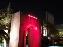 The waterfall arch at the pool at  night ( colours switch from red to green to blue to purple). Pool is closed at 7pm but nice to walk around after a work out in the gym